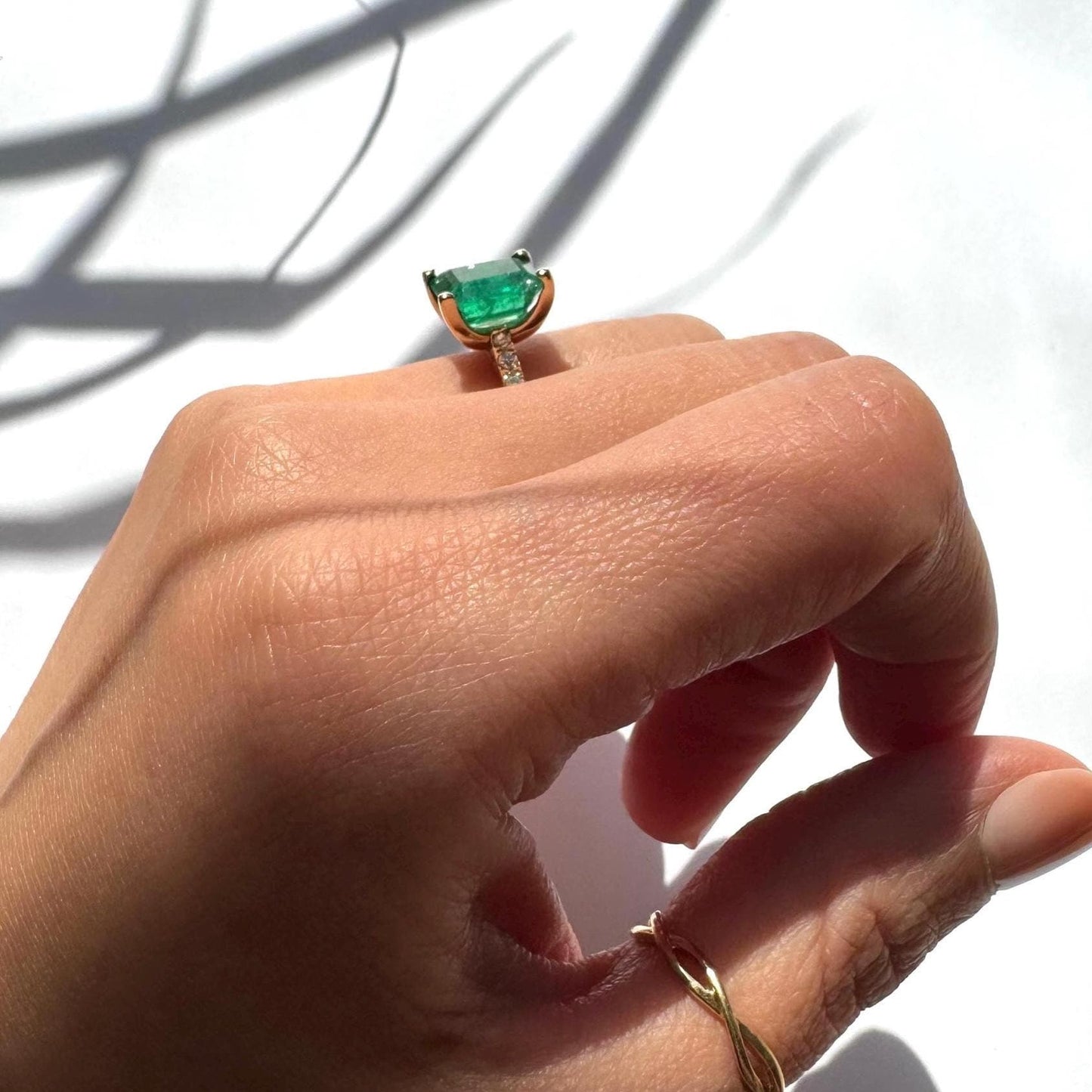 a girl wearing 14k yellow gold ring with authentic natural emerald and natural diamonds engagement ring anniversary ring