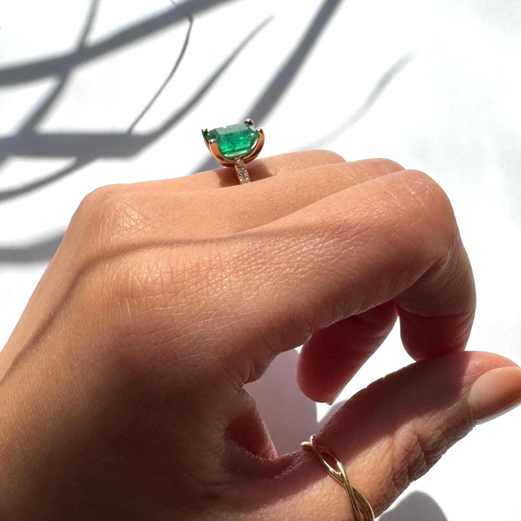 a girl wearing 14k yellow gold ring with authentic natural emerald and natural diamonds engagement ring anniversary ring
