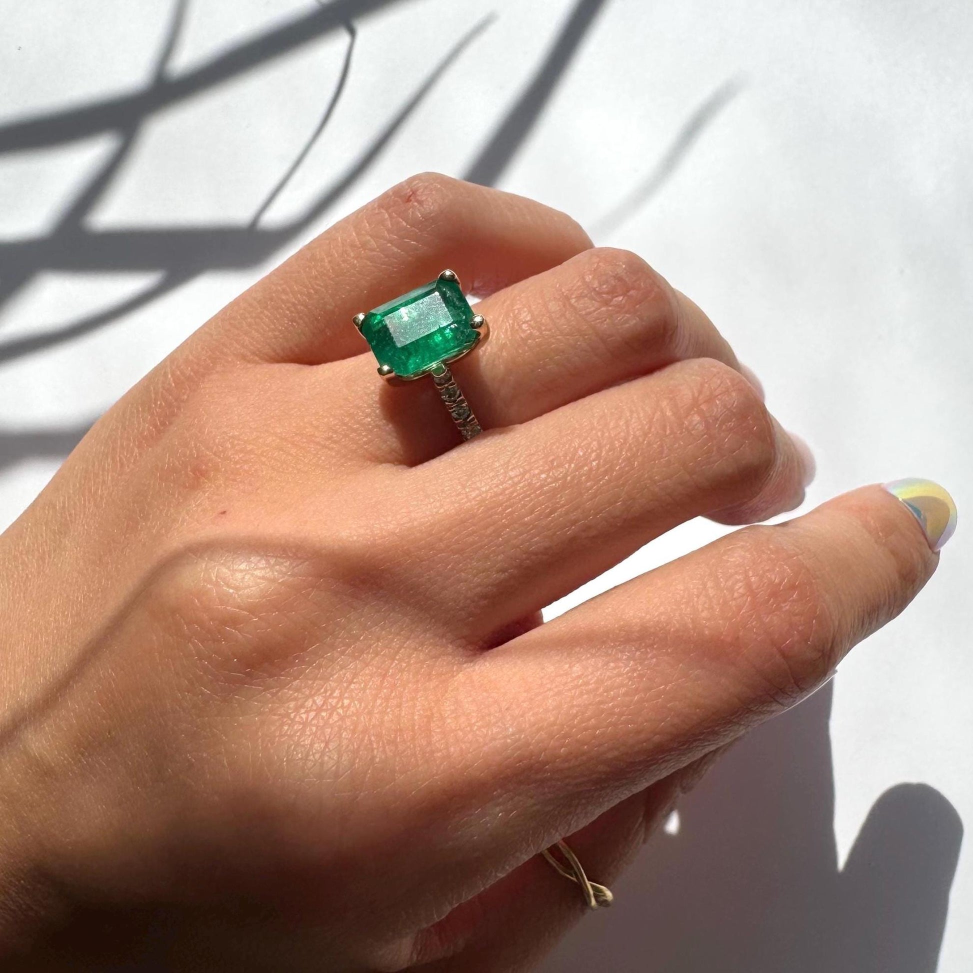 a girl wearing 14k yellow gold ring with authentic natural emerald and natural diamonds engagement ring anniversary ring