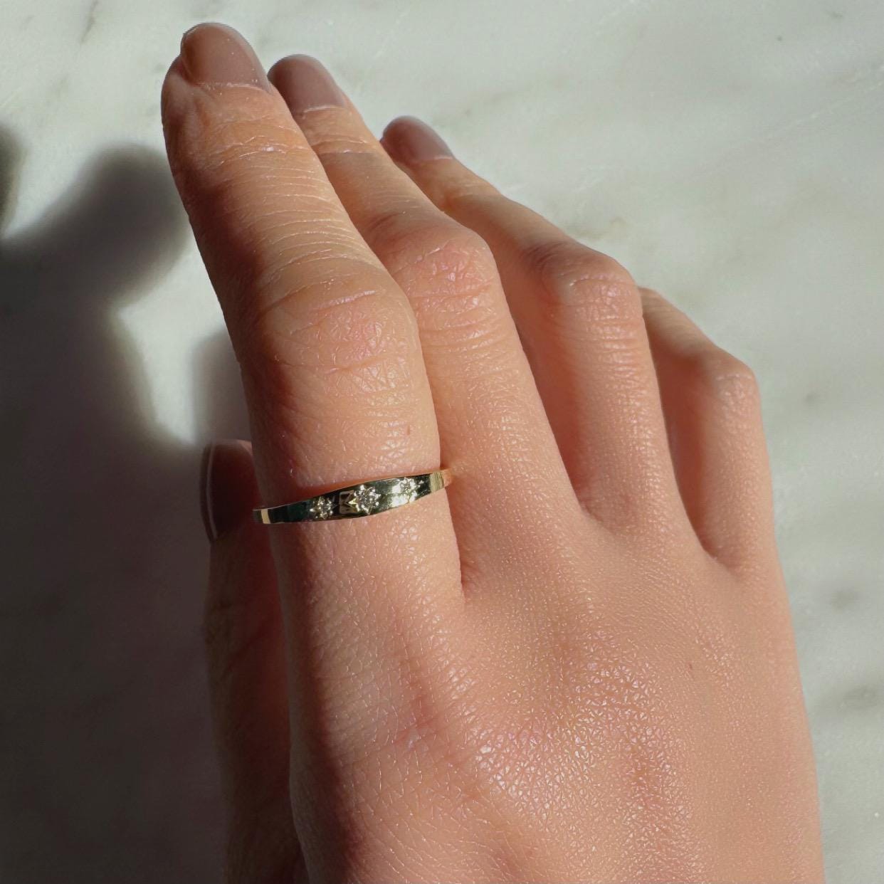 a girl wearing 3 diamond gypsy style ring made with authentic diamonds and 14k solid yellow gold celestial ring