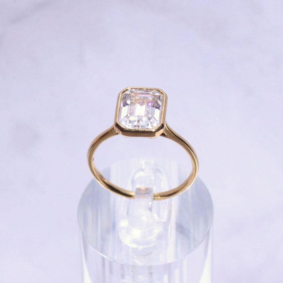 14k Gold Emerald Cut Moissanite Casey Ring: Lightweight Bezel Setting