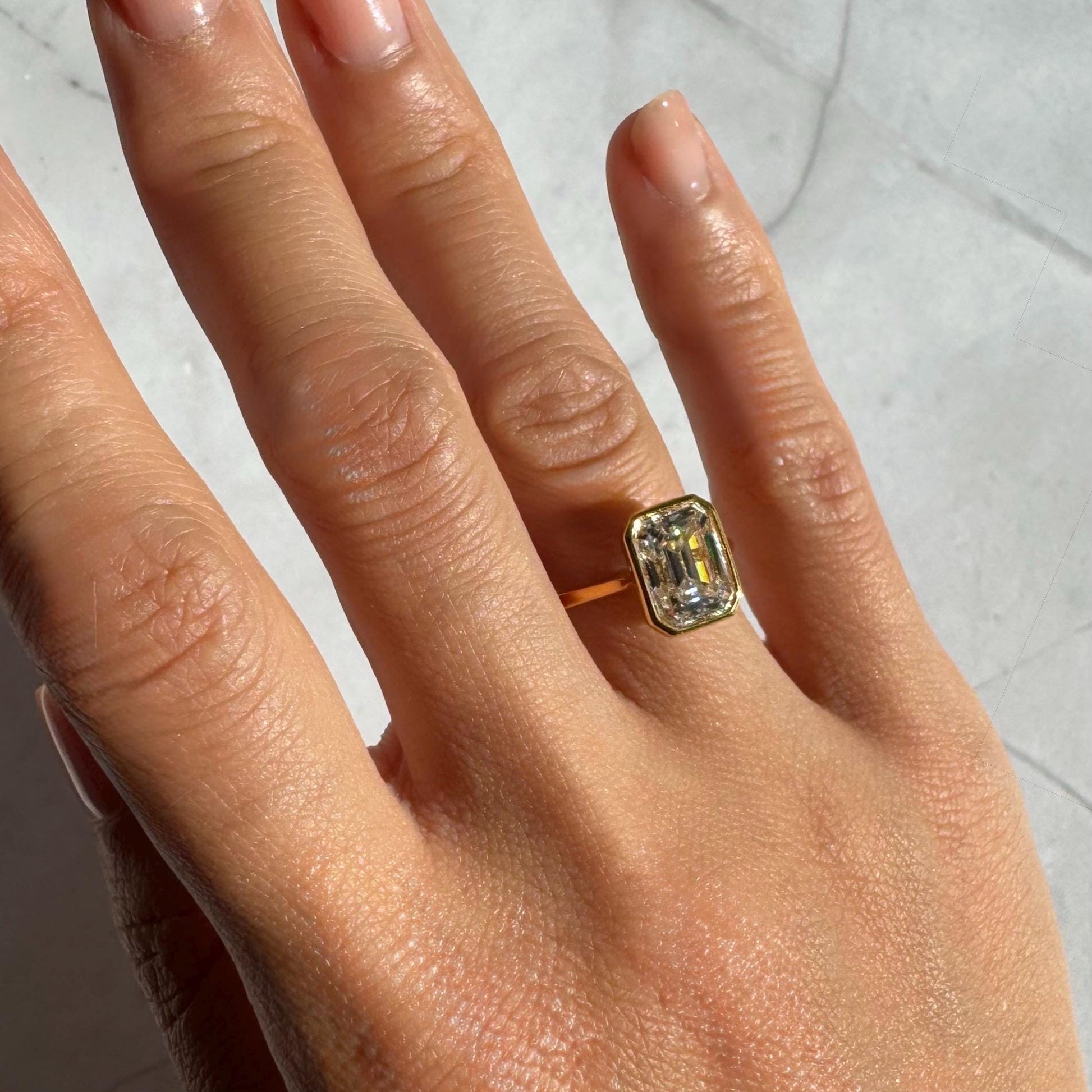 14k Gold Emerald Cut Moissanite Casey Ring: Lightweight Bezel Setting