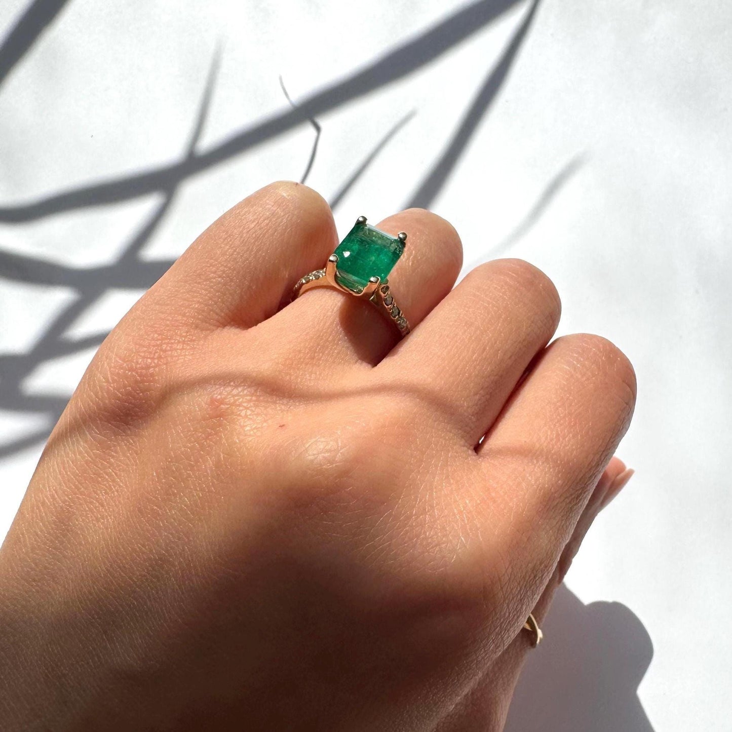 a girl wearing 14k yellow gold ring with authentic natural emerald and natural diamonds engagement ring anniversary ring