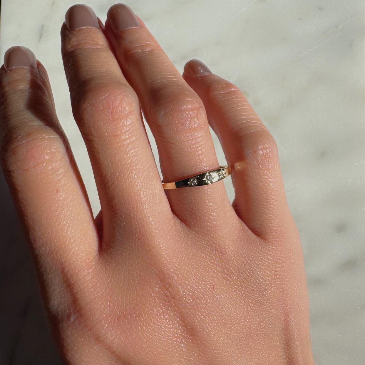 a girl wearing 3 diamond gypsy style ring made with authentic diamonds and 14k solid yellow gold celestial ring