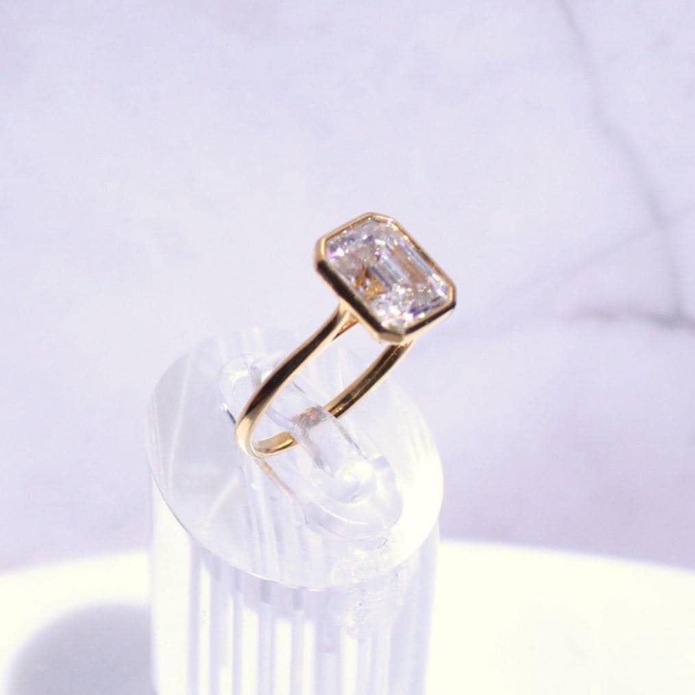14k Gold Emerald Cut Moissanite Casey Ring: Lightweight Bezel Setting